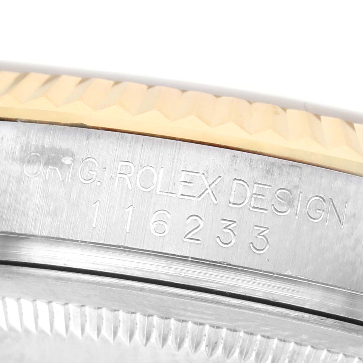 The image shows a close-up of the Rolex Datejust 116233 Men's Steel and Gold (two tone) White Dial model's engraved case side and fluted bezel.