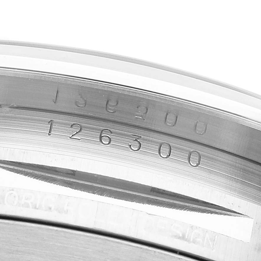 The image shows the inner bezel with engravings of the Rolex Datejust 41 126300 Men's Stainless Steel White Dial model, viewed up close.