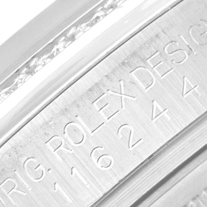 The image shows a close-up of the engraved serial/model number and "ROLEX DESIGN" text on a Rolex Datejust 116244 Men's Stainless Steel Brown Dial 116244 Men's Stainless Steel Brown Dial watch.