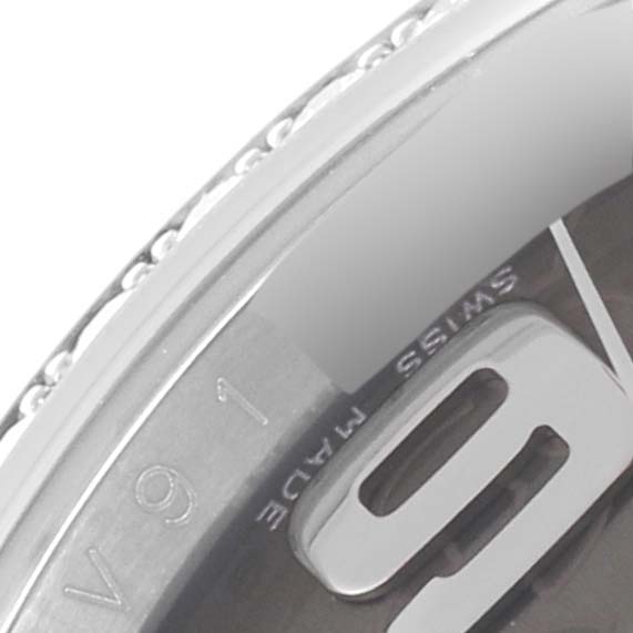 The image shows a close-up of the bezel and part of the dial of a Rolex Datejust 116244 Men's Stainless Steel Brown Dial 116244 Men's Stainless Steel Brown Dial watch, including the number "6" and "SWISS MADE" text.