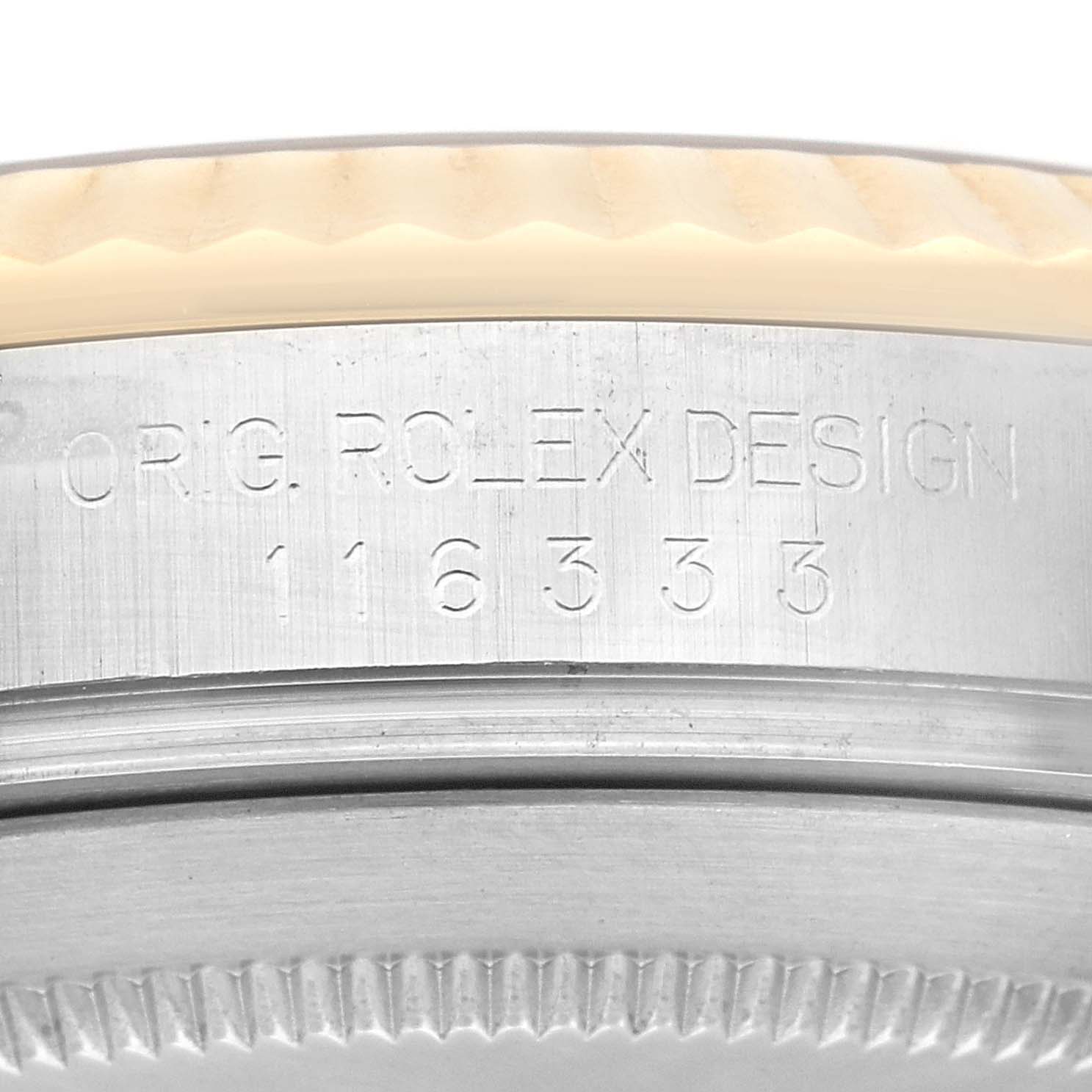 The image shows a close-up of the case side of a Rolex Datejust 41 116333 Men's Steel and Gold (two tone) Champagne Dial 116333 Men's Steel and Gold (two tone) Champagne Dial, highlighting the engraved serial and design numbers.