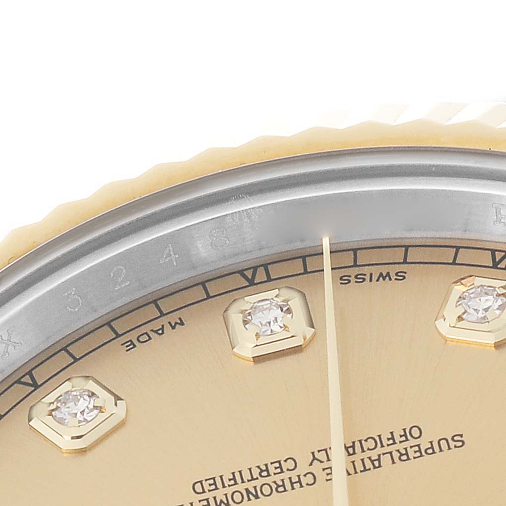 This close-up image of the Rolex Datejust 41 116333 Men's Steel and Gold (two tone) Champagne Dial 116333 Men's Steel and Gold (two tone) Champagne Dial watch shows a portion of the gold dial with diamond hour markers and the edge of the fluted bezel.