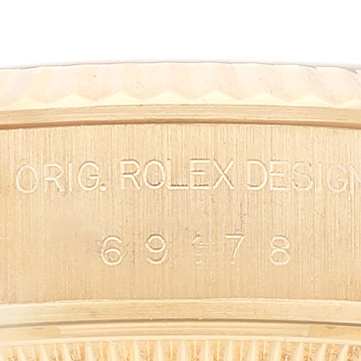 This image shows a close-up of the case side and serial number engraving on a Rolex President 69178 Women's Yellow Gold Champagne Dial 69178 Women's Yellow Gold Champagne Dial model.