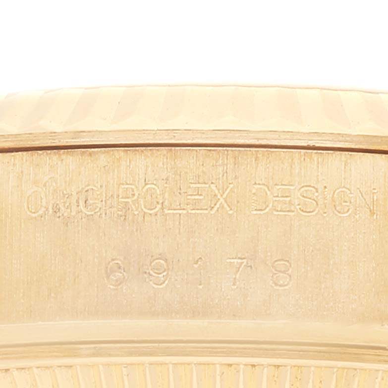 This image shows a close-up of the engraved side of a Rolex President 69178 Women
s Yellow Gold Champagne Dial 69178 Women
s Yellow Gold Champagne Dial watch case.