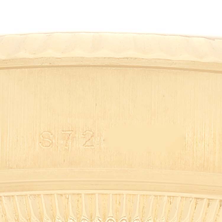 The image shows a close-up of the bezel and part of the case, engraved with serial numbers, of a Rolex President 69178 Women
s Yellow Gold Champagne Dial 69178 Women
s Yellow Gold Champagne Dial model watch.