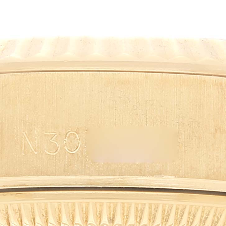 This close-up image shows the side of the case and bezel of a Rolex President 69178 Women
s Yellow Gold Champagne Dial 69178 Women
s Yellow Gold Champagne Dial model watch, focusing on the serial number engraving.