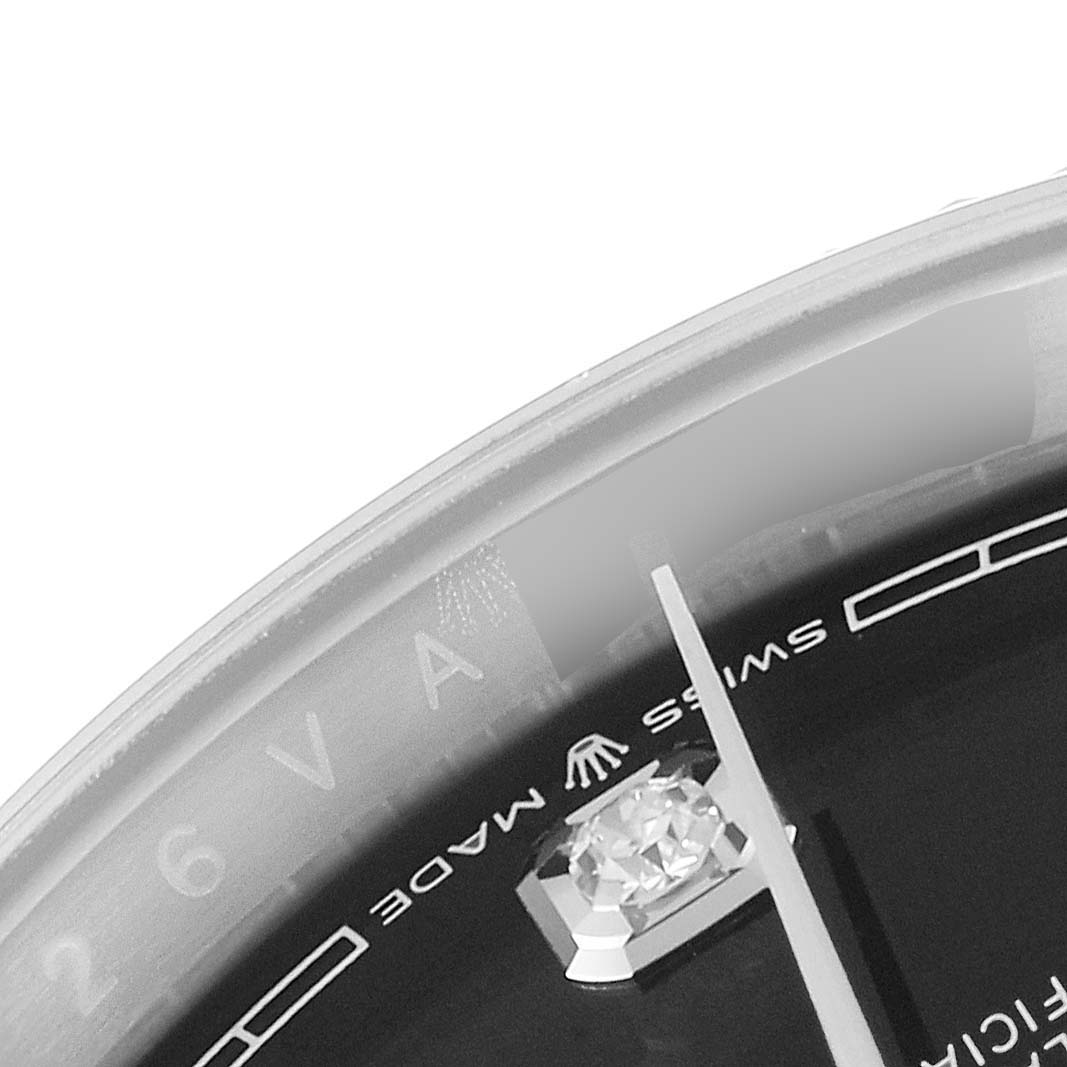 This image shows a close-up of the dial and part of the bezel of a Rolex Datejust 126234 Men
s Stainless Steel Black Dial 126234 Men
s Stainless Steel Black Dial watch, featuring the "Swiss Made" text and a diamond marker.