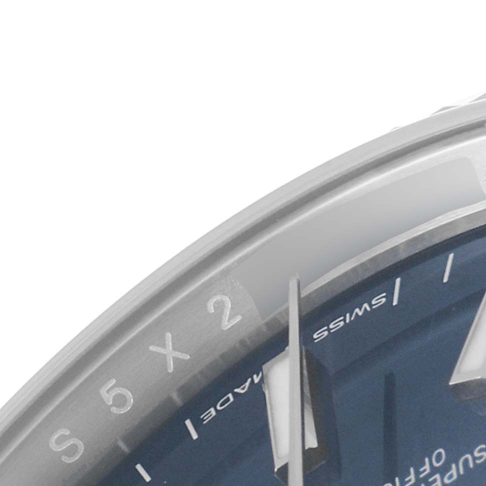 This is a close-up shot of a Rolex Datejust 126234 Men's Stainless Steel Blue Dial 126234 Men's Stainless Steel Blue Dial watch, focusing on the dial, hand, and part of the bezel.