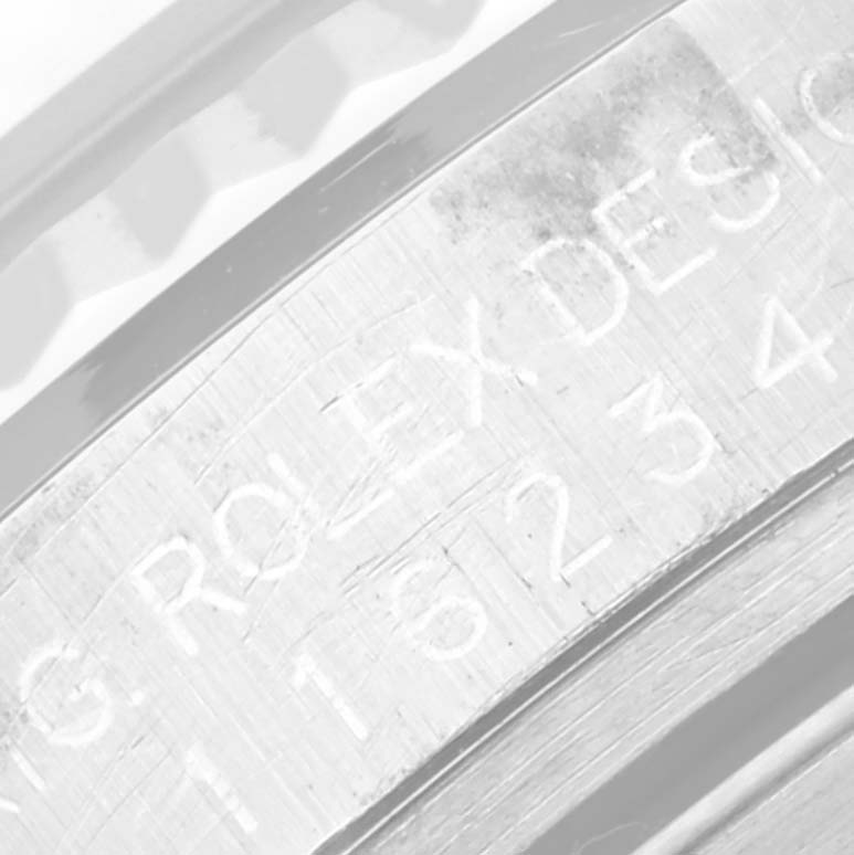 This close-up shows an engraving on the inner bezel of a Rolex Datejust 116234 Men's Stainless Steel Silver Dial 116234 Men's Stainless Steel Silver Dial watch.