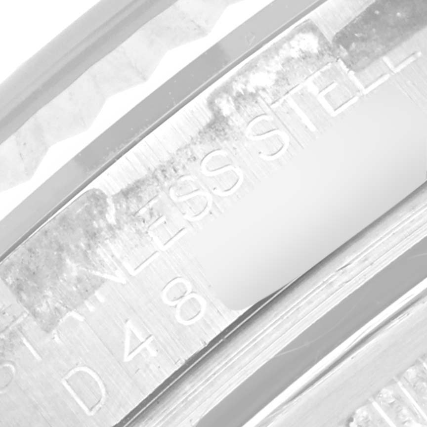 This close-up image shows the engraving on the inner bezel of a Rolex Datejust 116234 Men's Stainless Steel Silver Dial 116234 Men's Stainless Steel Silver Dial watch.