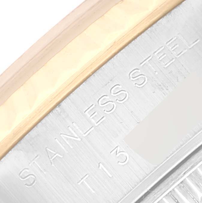 Close-up view of the side of a Rolex Datejust 69173 Women's Steel and Gold (two tone) Beige Dial 69173 Women's Steel and Gold (two tone) Beige Dial, showing "STAINLESS STEEL" engraving and part of the bezel.