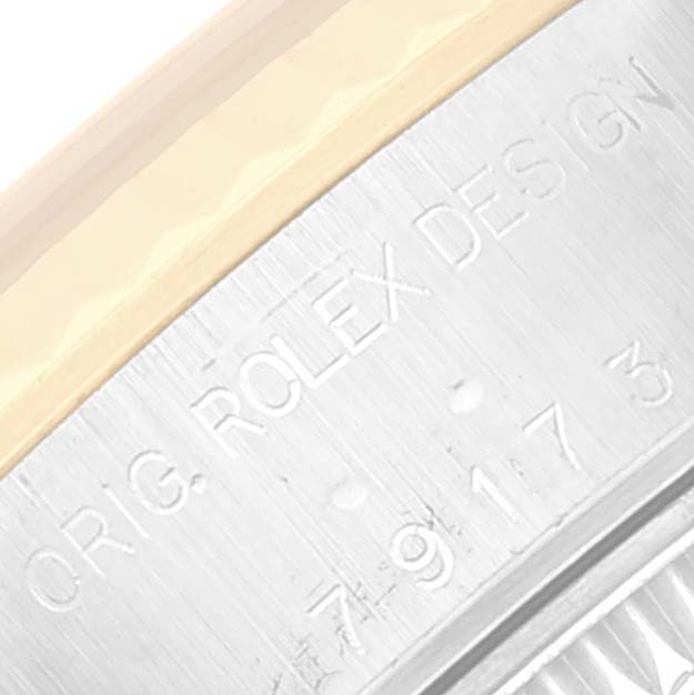 This image shows a close-up of the case side of a Rolex Datejust 79173 Women's Steel and Gold (two tone) Champagne Dial 79173 Women's Steel and Gold (two tone) Champagne Dial watch, displaying model engravings.