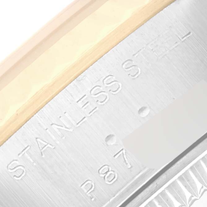 The image shows a close-up of the stainless steel case and some inscriptions on a Rolex Datejust 79173 Women's Steel and Gold (two tone) Champagne Dial 79173 Women's Steel and Gold (two tone) Champagne Dial watch.