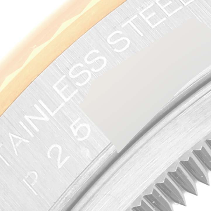 This close-up image shows part of the bezel and case of a Rolex Datejust 16233 Men's Steel and Gold (two tone) Champagne Dial 16233 Men's Steel and Gold (two tone) Champagne Dial watch, focusing on the text "STAINLESS STEEL."