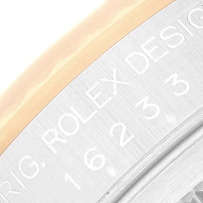 This close-up image shows the side engraving on the bezel area of a Rolex Datejust 16233 Men's Steel and Gold (two tone) Champagne Dial 16233 Men's Steel and Gold (two tone) Champagne Dial watch.