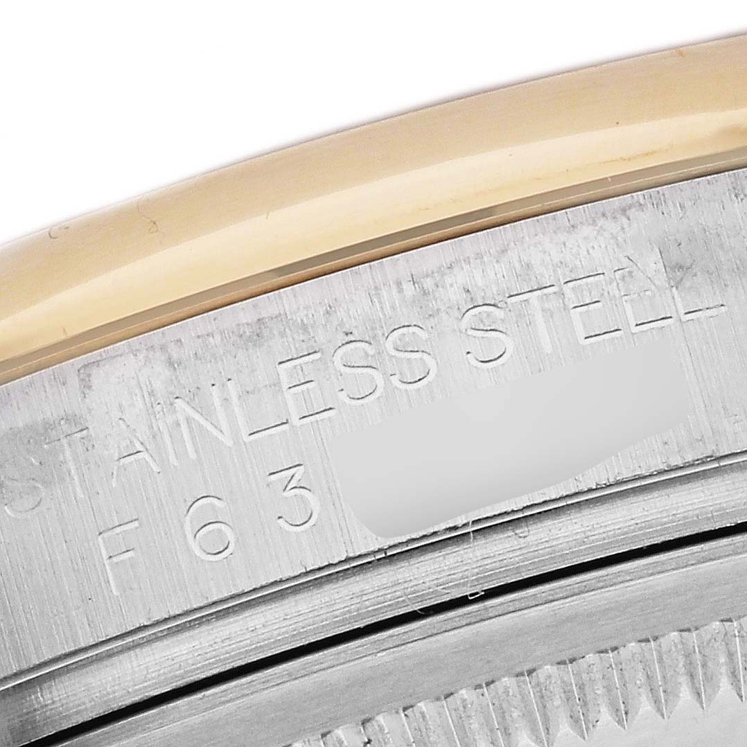 This close-up image shows the edge of the bezel and case of a Rolex Datejust 116203 Men's Steel and Gold (two tone) Silver Dial 116203 Men's Steel and Gold (two tone) Silver Dial watch, highlighting the "STAINLESS STEEL" engraving.