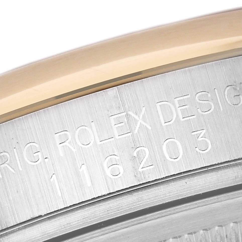 This image shows a close-up of the case back edge with the engraved serial number of a Rolex Datejust 116203 Men's Steel and Gold (two tone) Silver Dial 116203 Men's Steel and Gold (two tone) Silver Dial model.