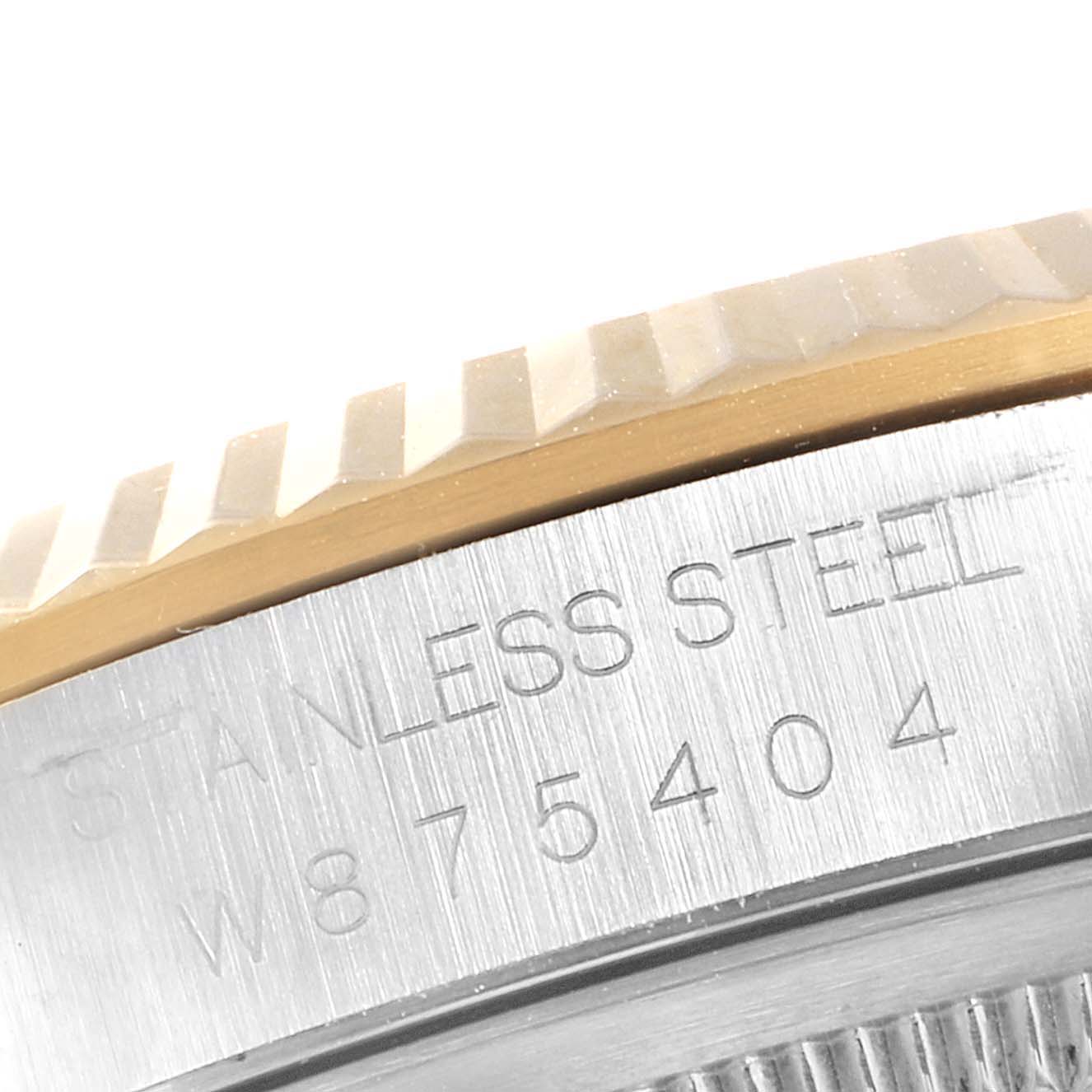 The image shows a close-up view of the engraved serial number and part of the bezel of a Rolex Datejust 16233 Men
s Steel and Gold (two tone) White Dial 16233 Men
s Steel and Gold (two tone) White Dial watch.