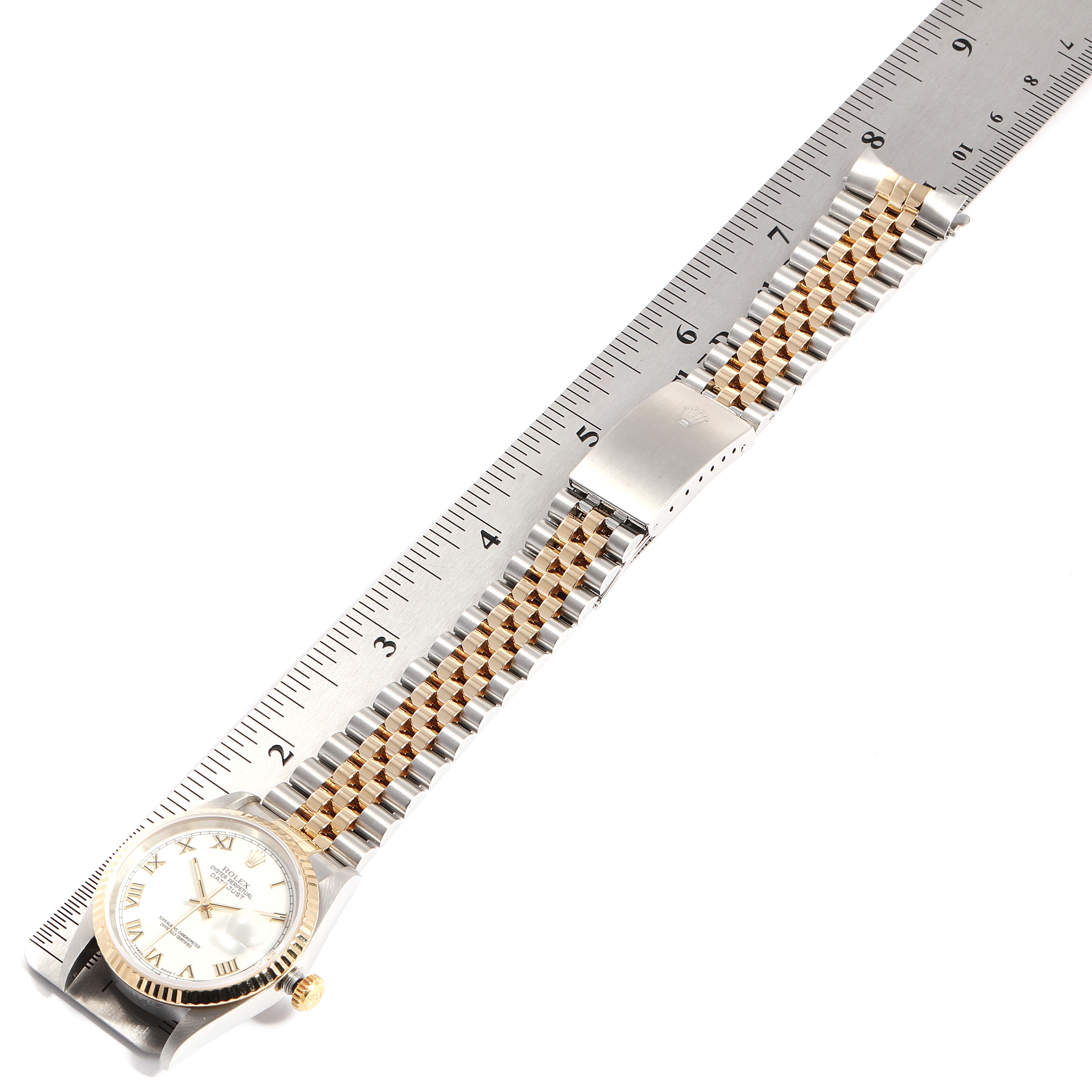 The Rolex Datejust 16233 Men
s Steel and Gold (two tone) White Dial 16233 Men
s Steel and Gold (two tone) White Dial watch is shown from a top view, alongside a ruler, displaying its full length and two-tone bracelet.