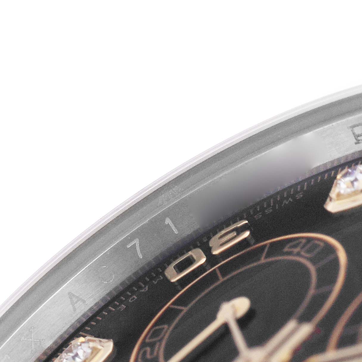 The image shows a close-up of the bezel and part of the dial of a Rolex Daytona 116503 Men's Steel and Gold (two tone) Black Dial watch, highlighting the watch face details.