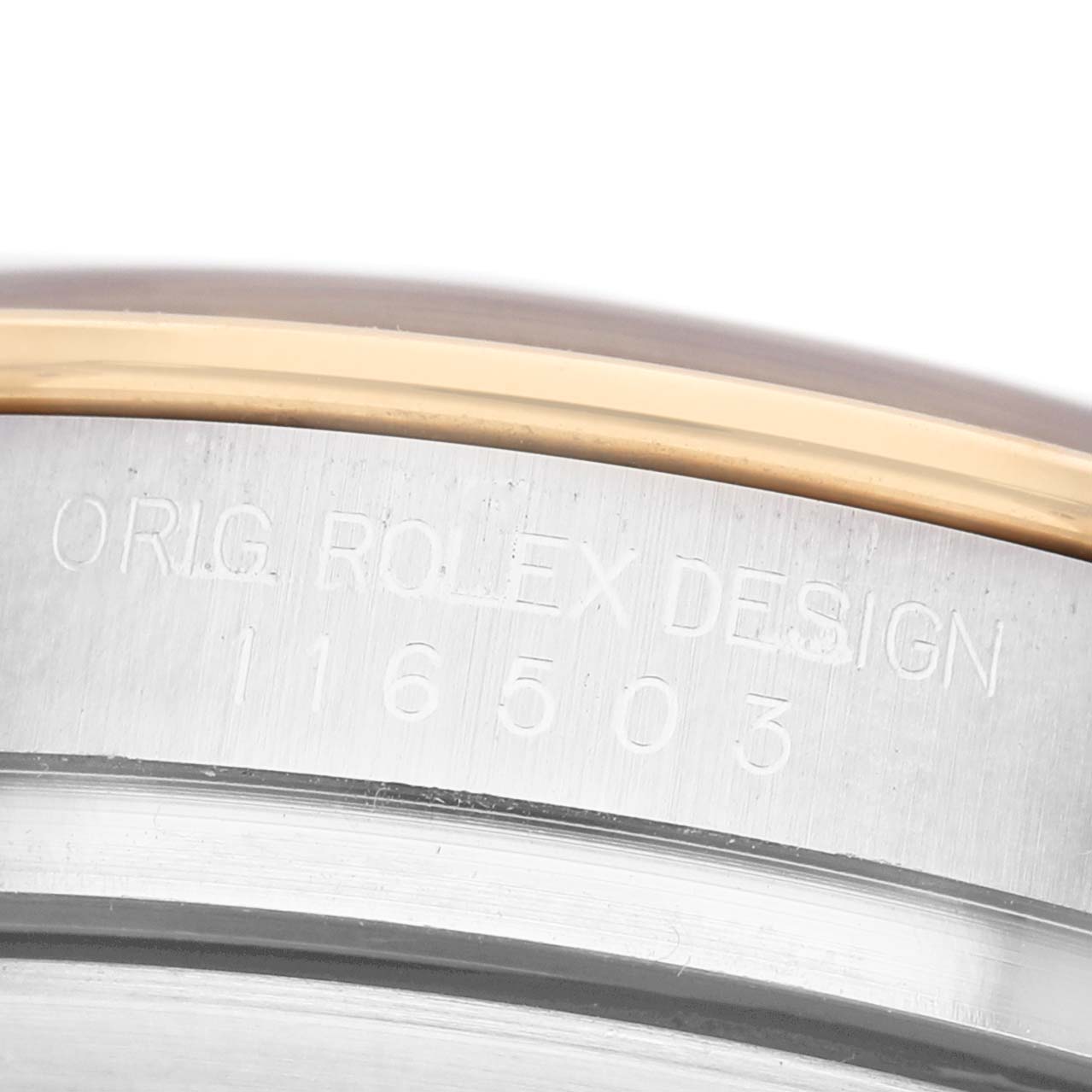 The image shows a close-up of a Rolex Daytona 116503 Men's Steel and Gold (two tone) Black Dial watch's side, highlighting the engraved model number and design.
