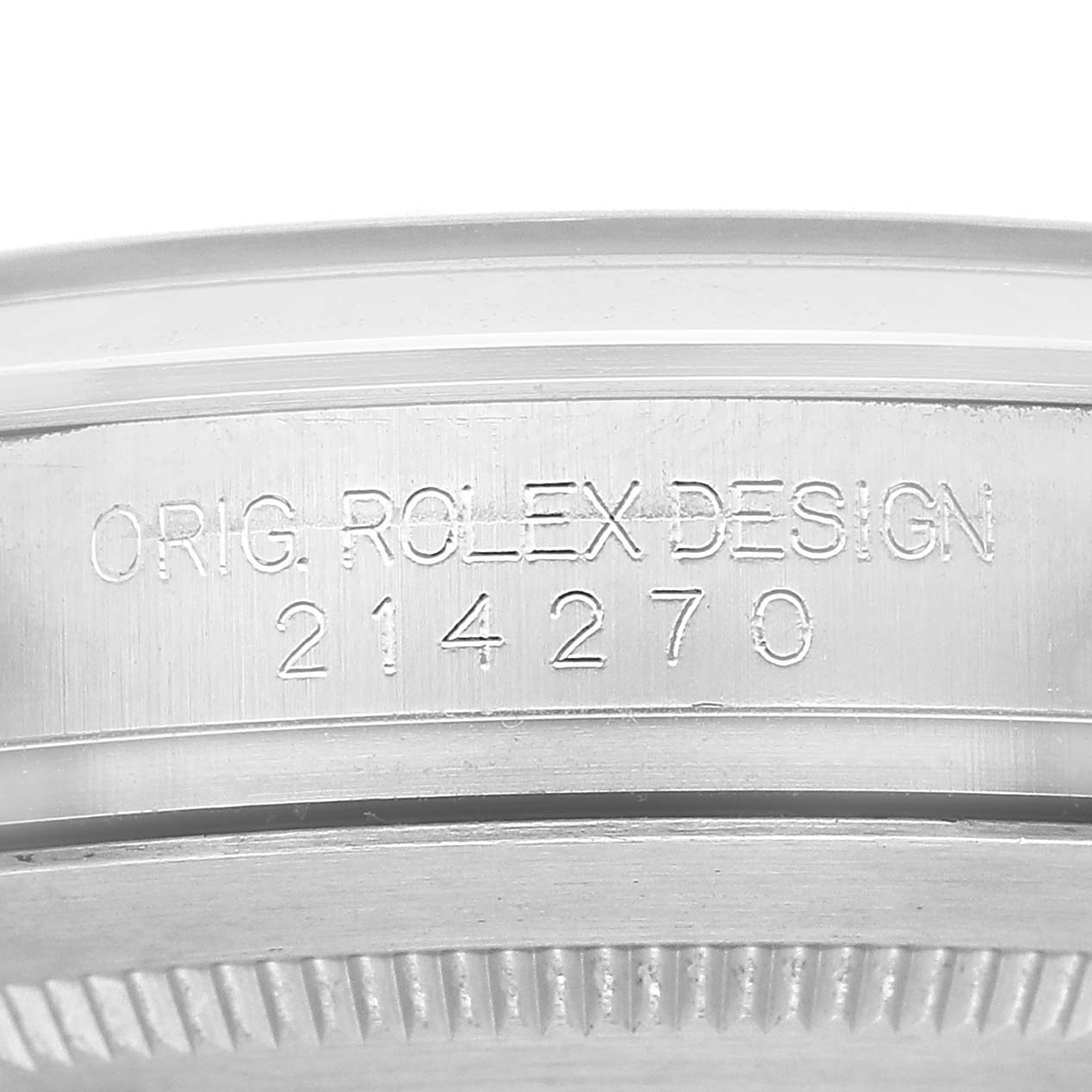 The image shows a close-up of the case side of a Rolex Explorer 214270 Men's Stainless Steel Black Dial, featuring engraved text with model number and design details.