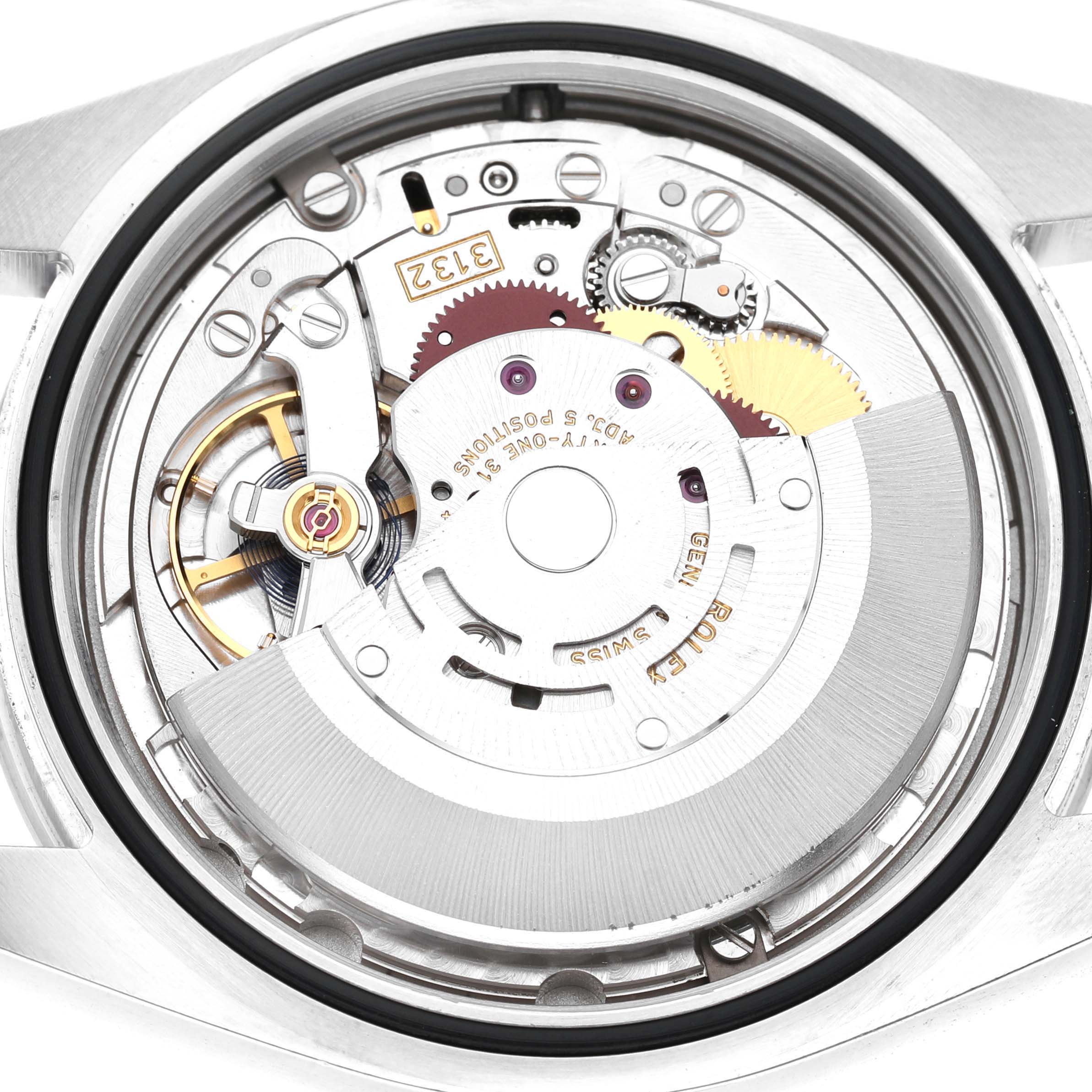 This image shows the internal movement of a Rolex Explorer 214270 Men's Stainless Steel Black Dial watch from the back, highlighting gears and mechanical parts.
