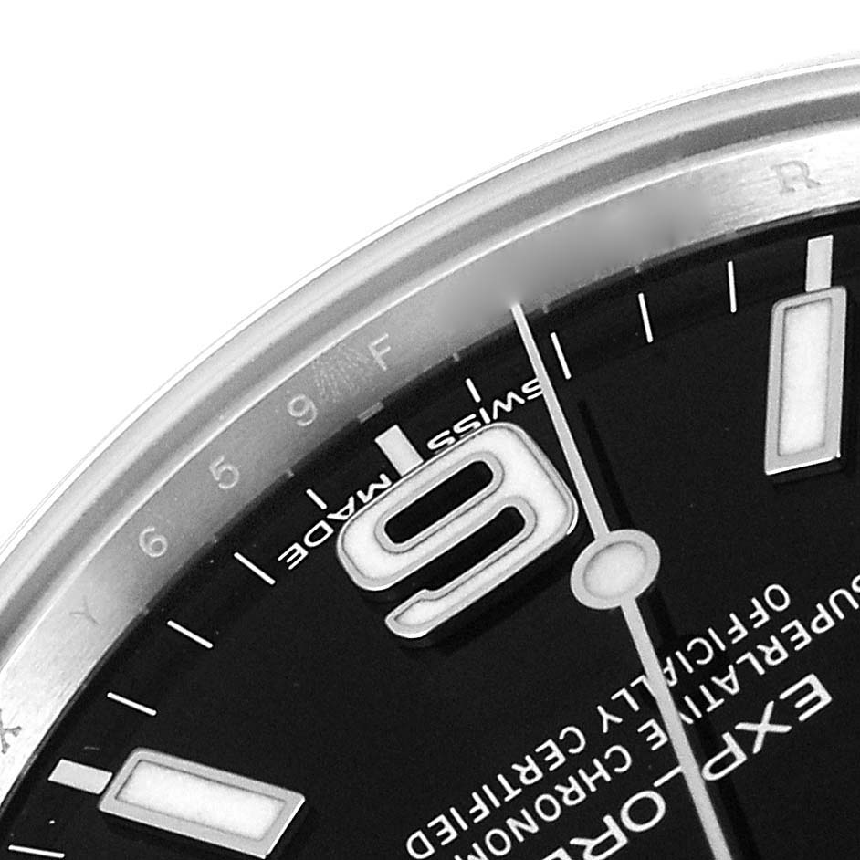 The close-up image shows part of the dial, hour markers, and hands of a Rolex Explorer 214270 Men
s Stainless Steel Black Dial 214270 Men
s Stainless Steel Black Dial watch.