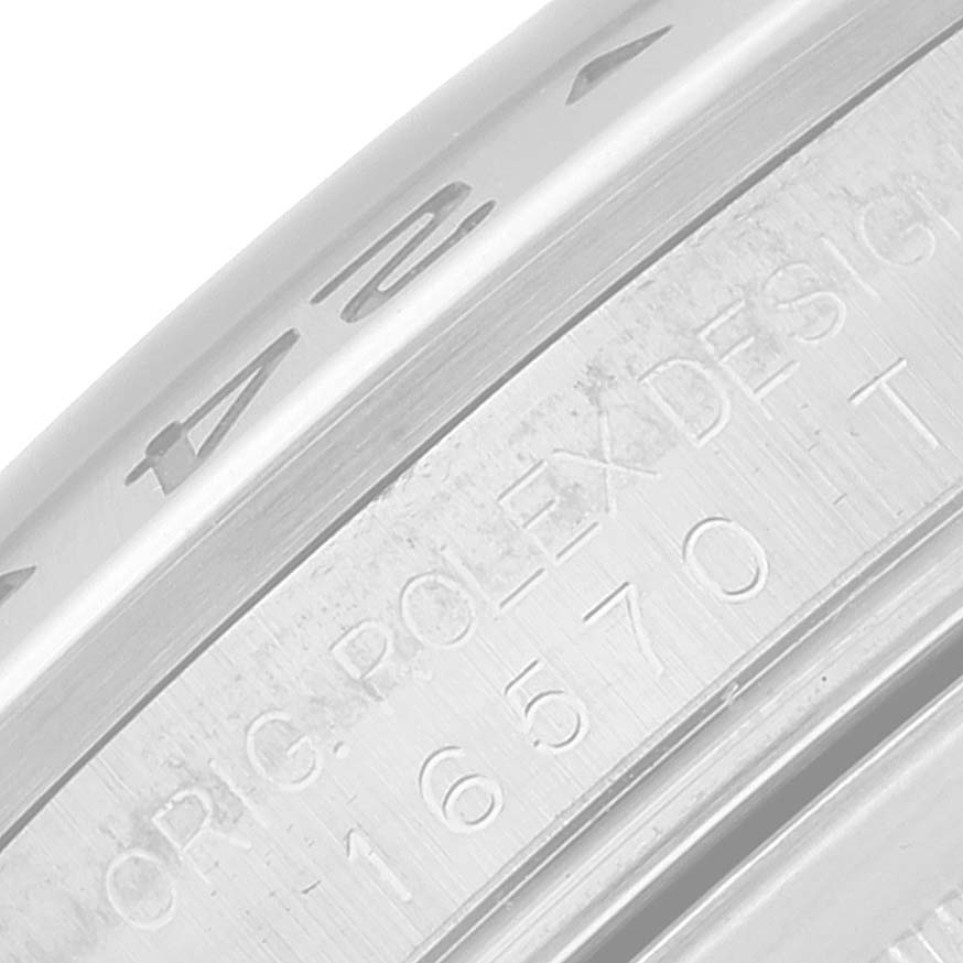 This image shows a close-up of the outer edge and inner bezel of a Rolex Explorer 16570 Men
s Stainless Steel Black Dial 16570 Men
s Stainless Steel Black Dial model, displaying engraving details.