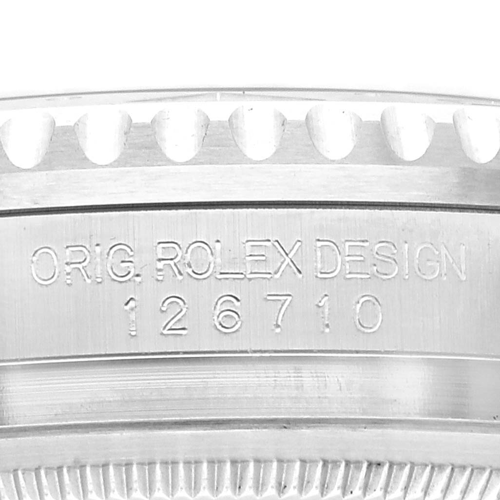 This image shows a close-up of the bezel and case side of the Rolex GMT-Master 126710 Men
s Stainless Steel Black Dial 126710 Men
s Stainless Steel Black Dial with the engraving "ORIG. ROLEX DESIGN 126710".