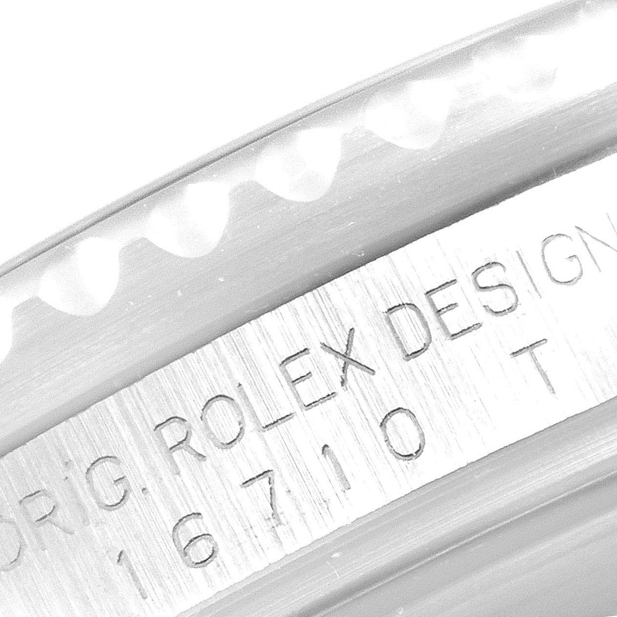 The image shows a close-up of the engraving on the side of a Rolex GMT-Master 16710 Men
s Stainless Steel Black Dial 16710 Men
s Stainless Steel Black Dial bezel and case, highlighting the model number 16710.