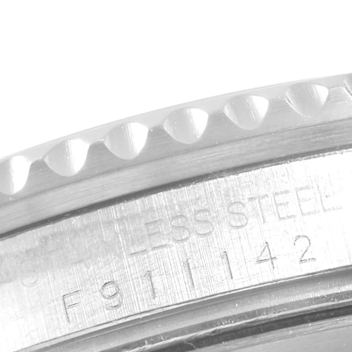 This close-up image shows the stainless steel bezel and engraved serial number of a Rolex GMT-Master 16710 Men
s Stainless Steel Black Dial 16710 Men
s Stainless Steel Black Dial watch.
