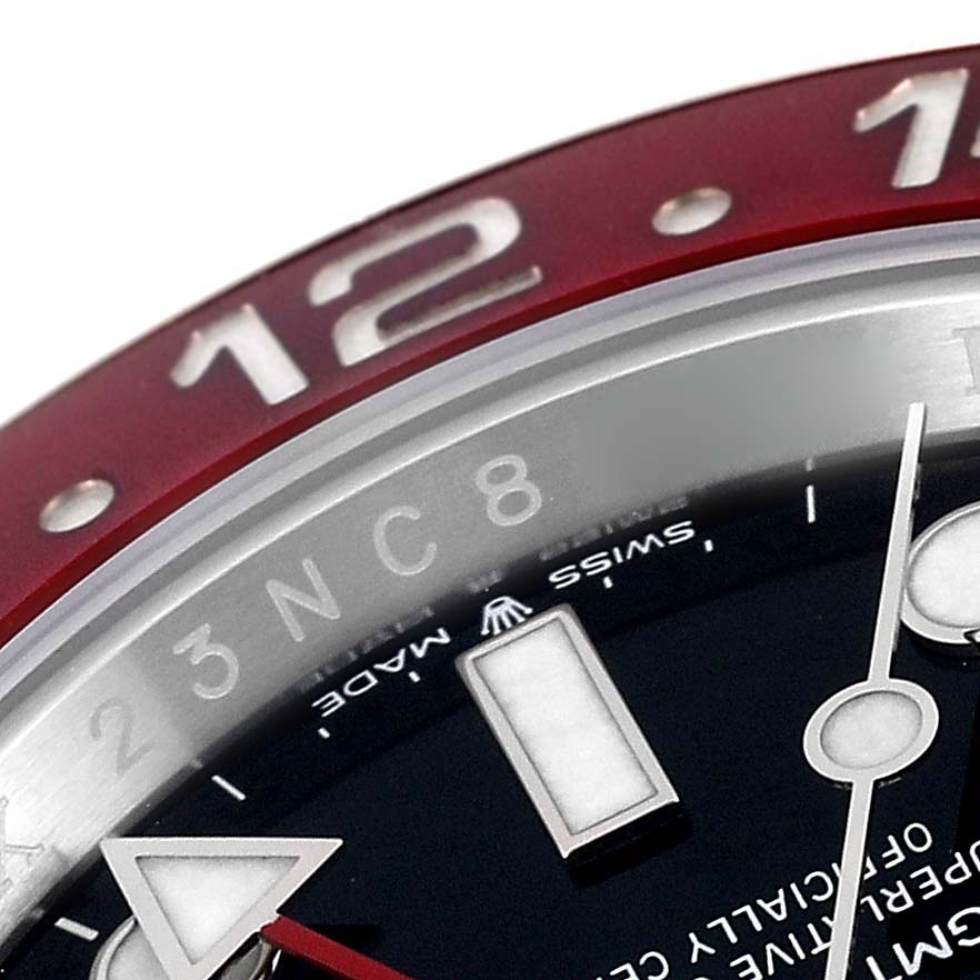 This close-up image of a Rolex GMT-Master 126710 Men
s Stainless Steel Black Dial 126710 Men
s Stainless Steel Black Dial watch shows the dial, bezel, and part of the hour and minute hands.