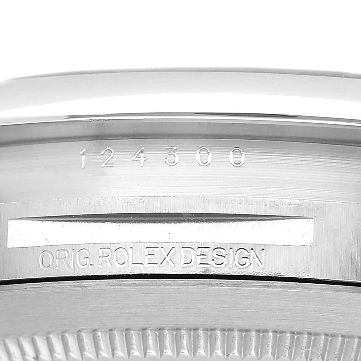 The image shows a close-up of the side case and bezel of a Rolex Oyster Perpetual M124300-0005 Men's Stainless Steel Green Dial, highlighting the model number and "ORIG. ROLEX DESIGN" engraving.