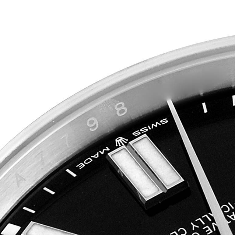 This image shows a partial close-up angle of the dial, hands, and markers of a Rolex Oyster Perpetual 124300 Men's Stainless Steel Black Dial 124300 Men's Stainless Steel Black Dial watch.