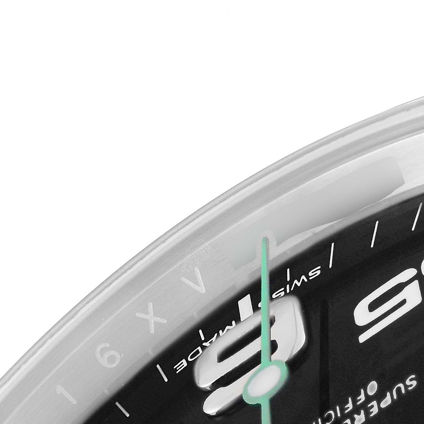 This image shows a close-up of the dial and part of the bezel of a Rolex Air-King 116900 Men's Stainless Steel Black Dial 116900 Men's Stainless Steel Black Dial watch.
