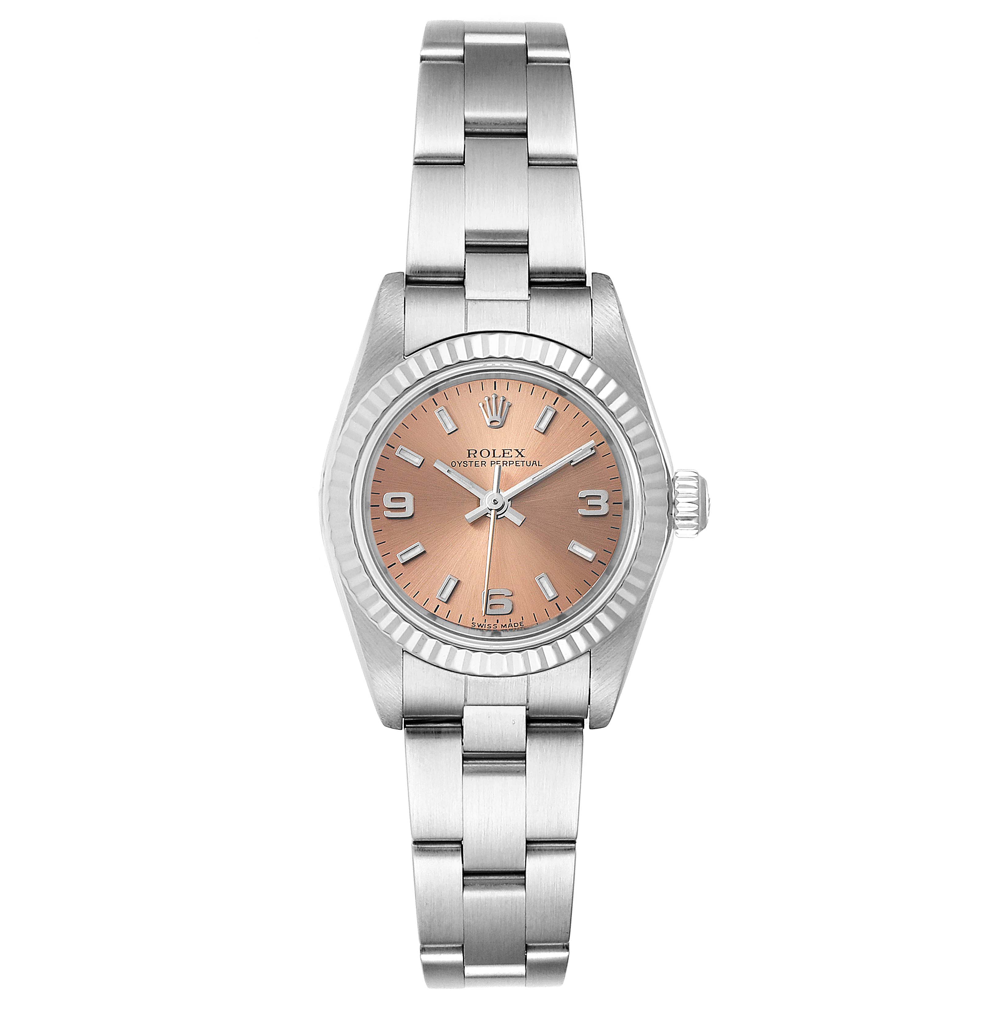 This image shows a frontal view of a Rolex Oyster Perpetual 76094 Women's Stainless Steel Pink Dial 76094 Women's Stainless Steel Pink Dial watch, featuring a metal strap and a peach-colored dial.