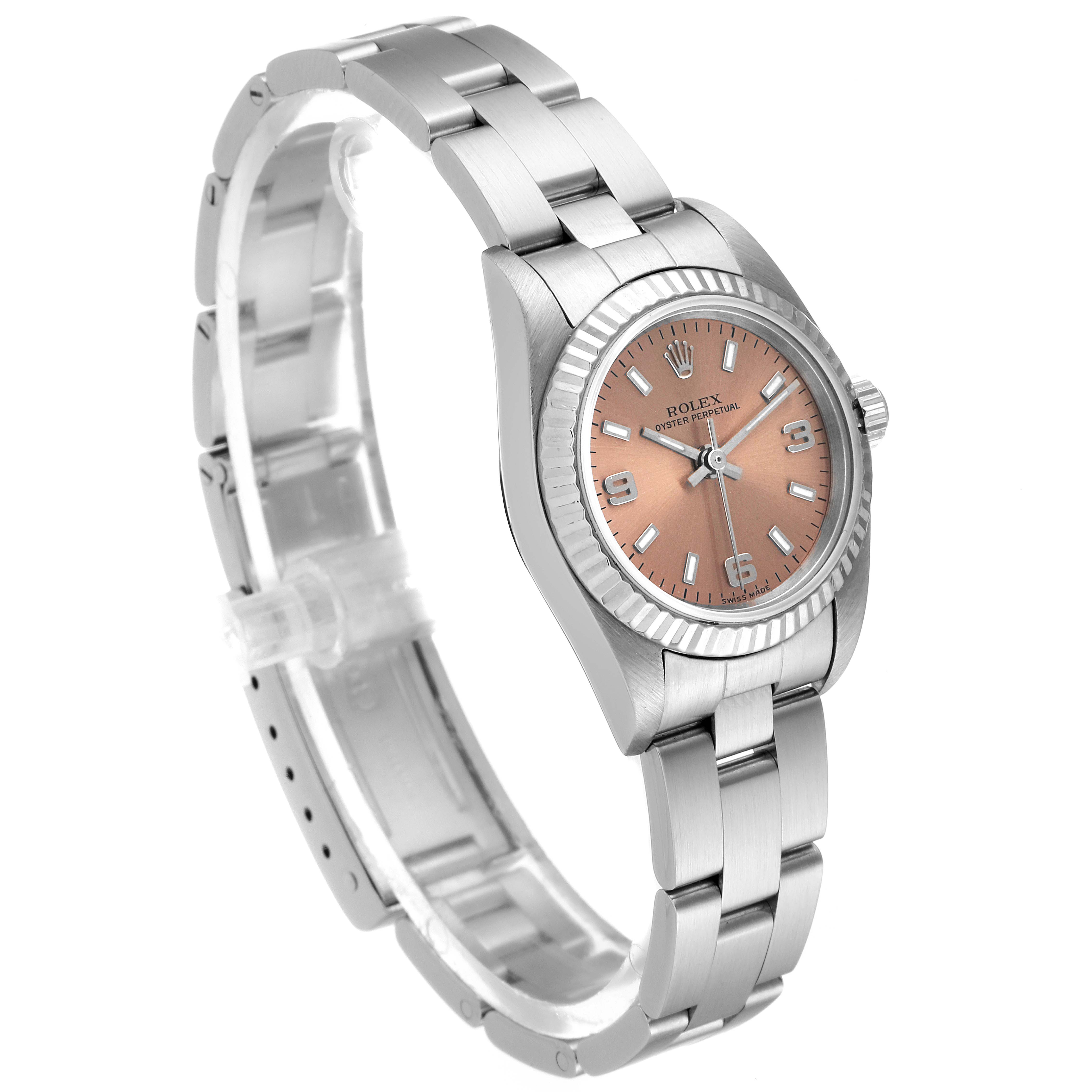 This image shows a Rolex Oyster Perpetual 76094 Women's Stainless Steel Pink Dial 76094 Women's Stainless Steel Pink Dial watch angled to display the face, bezel, crown, and part of the bracelet.