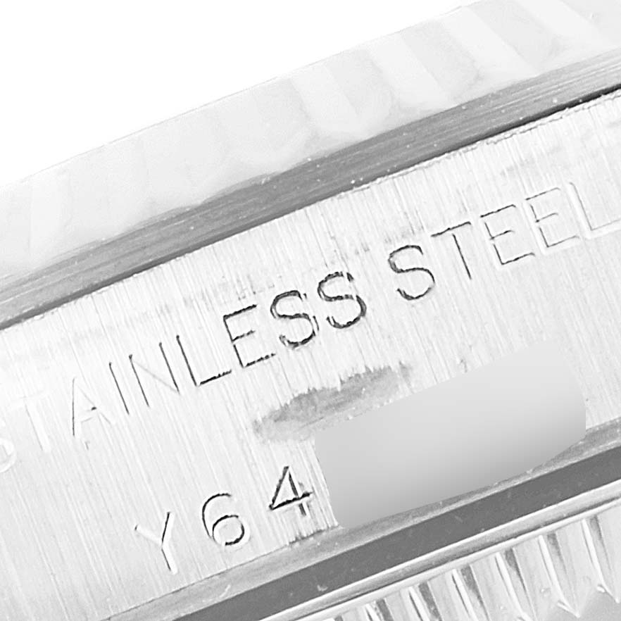 The image shows a close-up of the serial number engraving on the stainless steel case of a Rolex Oyster Perpetual 76094 Women's Stainless Steel Pink Dial 76094 Women's Stainless Steel Pink Dial watch.