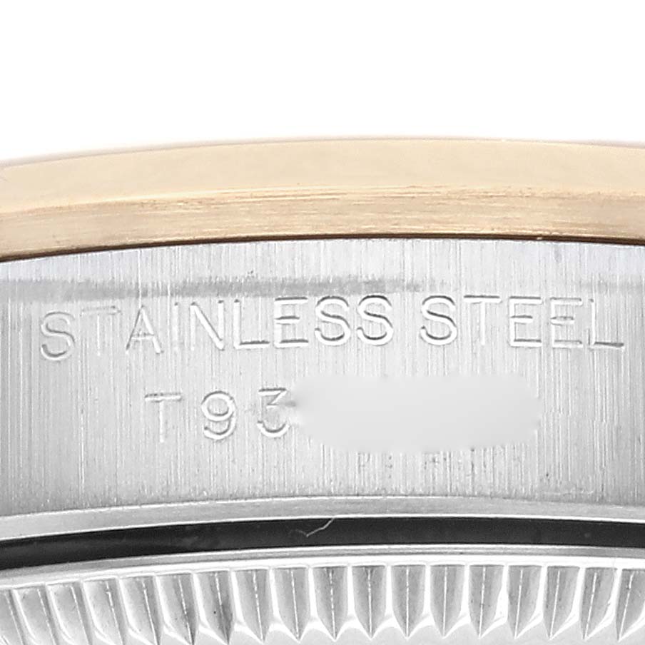 The image shows a close-up of the side of the bezel and case of a Rolex Oyster Perpetual 67183 Women's Steel and Gold (two tone) Grey Dial 67183 Women's Steel and Gold (two tone) Grey Dial watch, highlighting the "Stainless Steel" engraving.