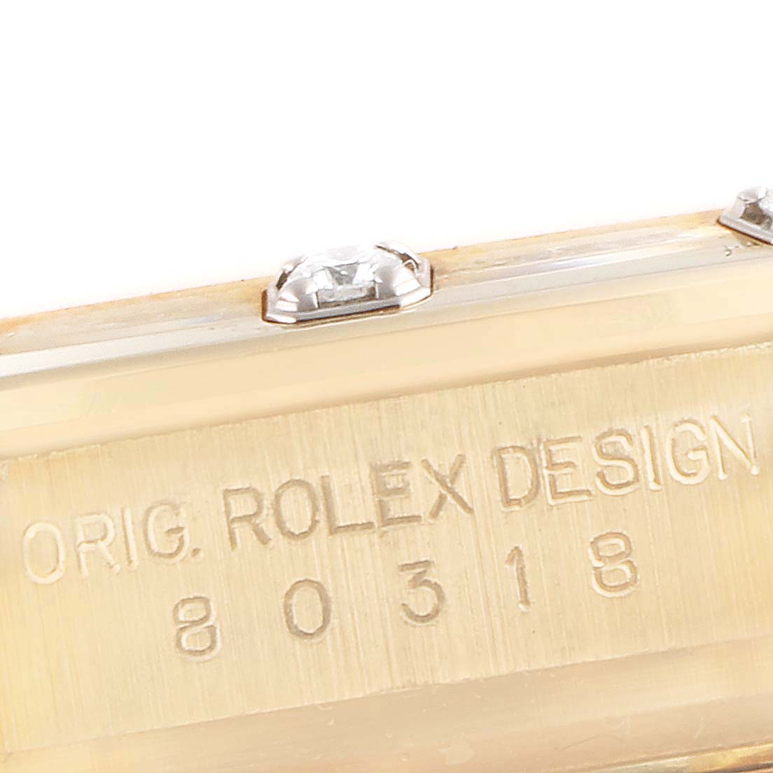 This image shows a close-up of the side engraving and diamond details on a Rolex Pearlmaster 80318 Women's Yellow Gold Mother of Pearl Dial 80318 Women's Yellow Gold Mother of Pearl Dial watch case.