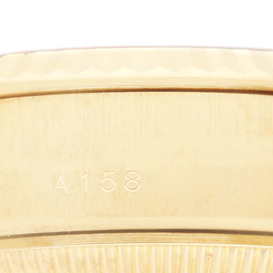 This close-up image of the Rolex President 79178 Women's Yellow Gold Champagne Dial 79178 Women's Yellow Gold Champagne Dial model shows the inner part of the watch case with an engraved number.