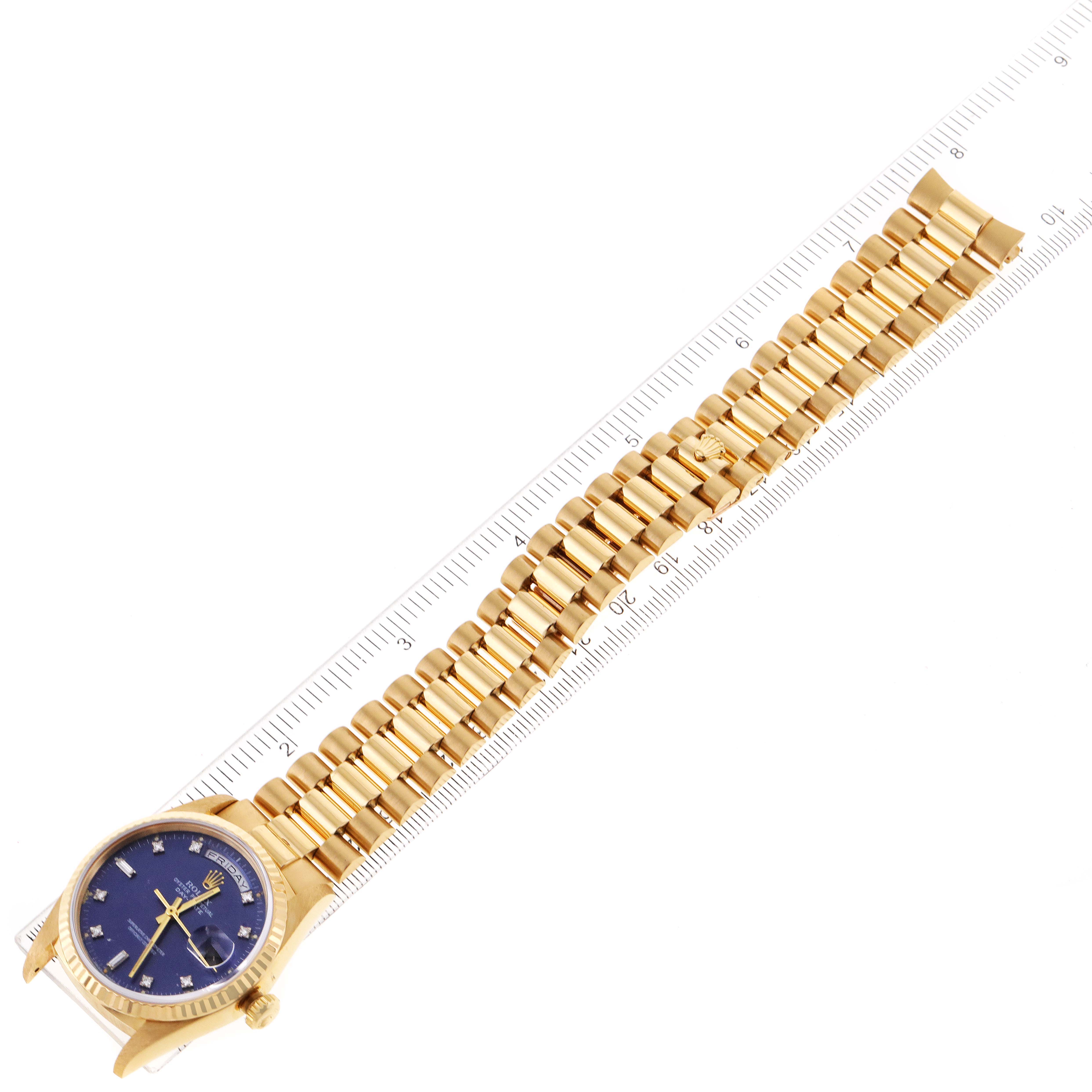 The image shows an overhead view of a Rolex President 18238 Men's Yellow Gold Blue Dial 18238 Men's Yellow Gold Blue Dial model watch, displaying its gold bracelet and blue dial.