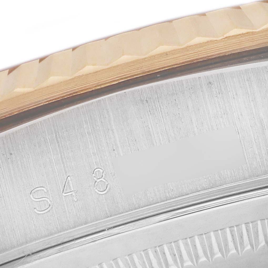 This close-up image is of the side edge, bezel, and part of the casing of a Rolex President 18239 Men's Steel and Gold (two tone) Champagne Dial 18239 Men's Steel and Gold (two tone) Champagne Dial model watch, showcasing engraved serial numbers.