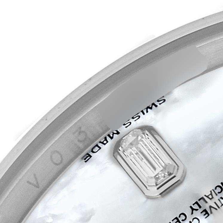 This close-up image of a Rolex President 118209 Men's White Gold Mother of Pearl Dial 118209 Men's White Gold Mother of Pearl Dial model watch shows a part of the dial with a diamond and "Swiss Made" text.