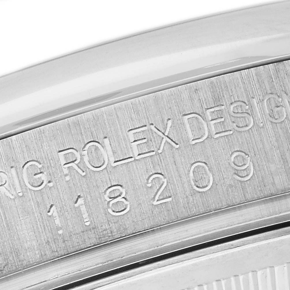 This close-up image shows the engraved case back of a Rolex President 118209 Men's White Gold Mother of Pearl Dial 118209 Men's White Gold Mother of Pearl Dial model, displaying the model number and brand name.