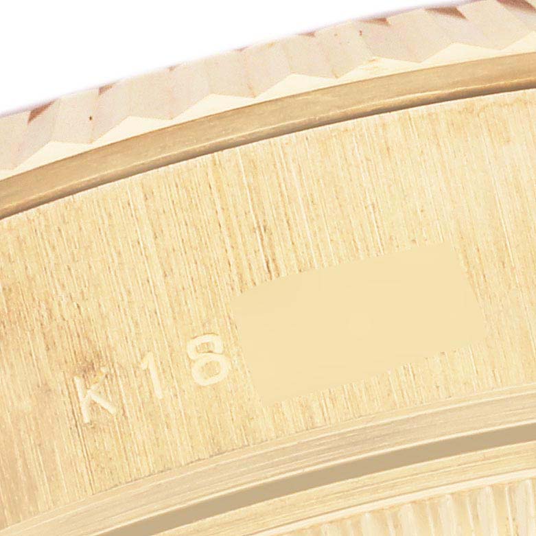This close-up image shows the edge of the bezel with part of the case of a Rolex President 79178 Women's Yellow Gold Champagne Dial 79178 Women's Yellow Gold Champagne Dial model watch.