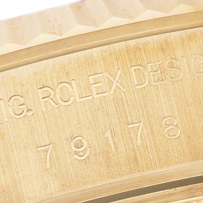 This close-up image shows the engraved markings and a portion of the bezel on a Rolex President 79178 Women's Yellow Gold Champagne Dial 79178 Women's Yellow Gold Champagne Dial model watch.