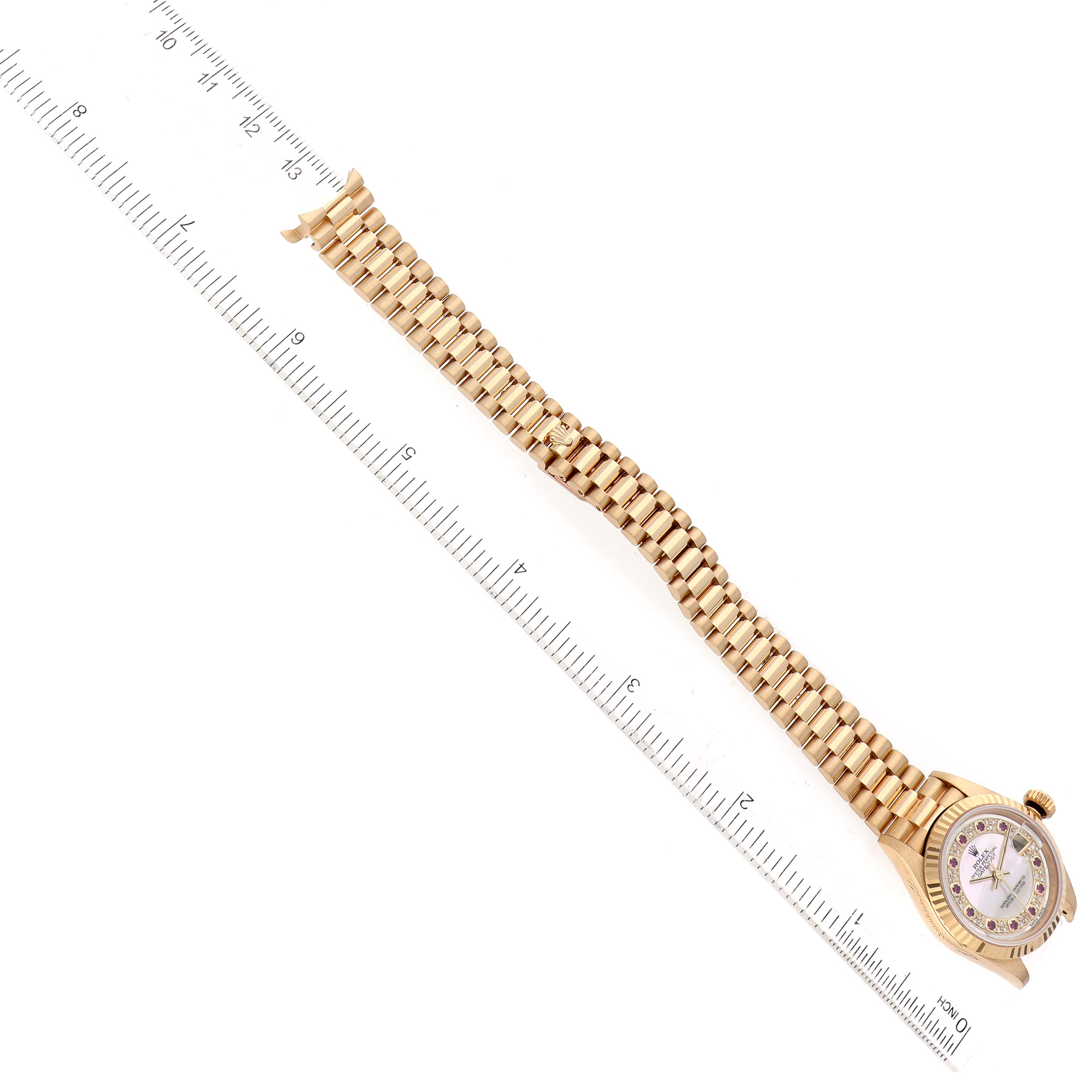 The image shows a gold Rolex President 79178 Women's Yellow Gold Champagne Dial 79178 Women's Yellow Gold Champagne Dial model watch laid flat with a ruler measuring its length.