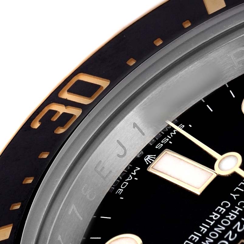 The image shows a close-up of the bezel and part of the dial of a Rolex Sea-Dweller M126603 Men's Steel and Gold (two tone) Black Dial watch, with visible indices and text.
